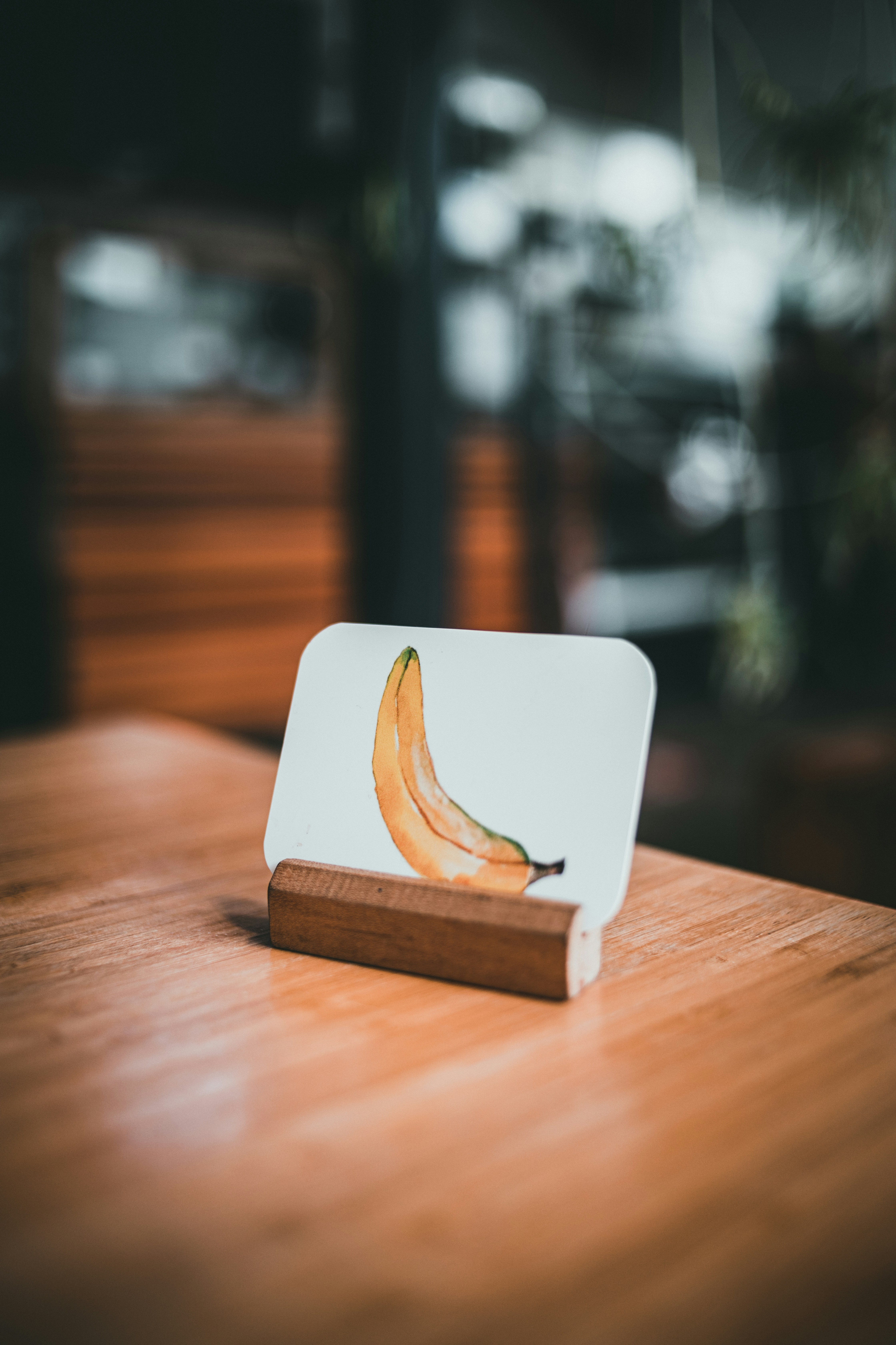 a banana sitting on top of a wooden table