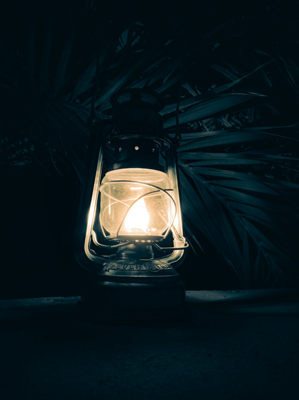 a lit lantern sitting on top of a table