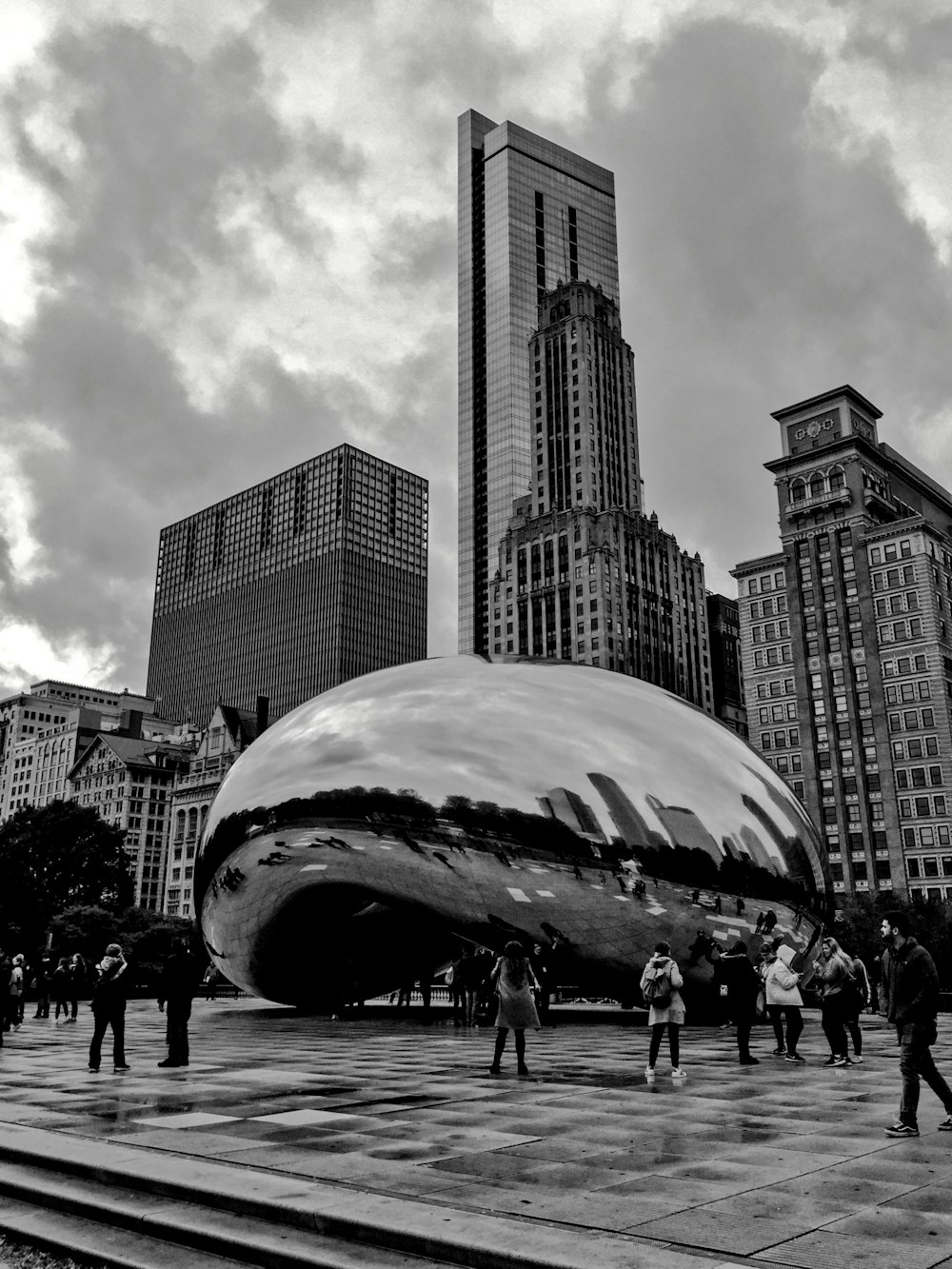 a black and white photo of people walking in a city