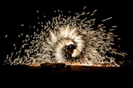 A dynamic VFX scene showing vibrant particle effects over a dark cityscape.