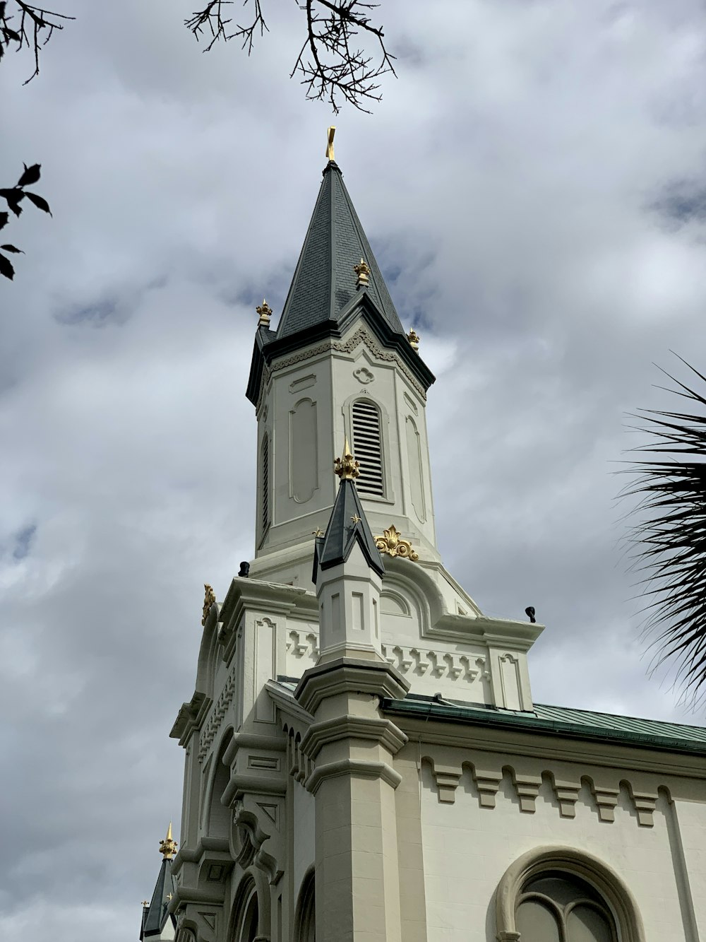 a tall white building with a clock on it's side