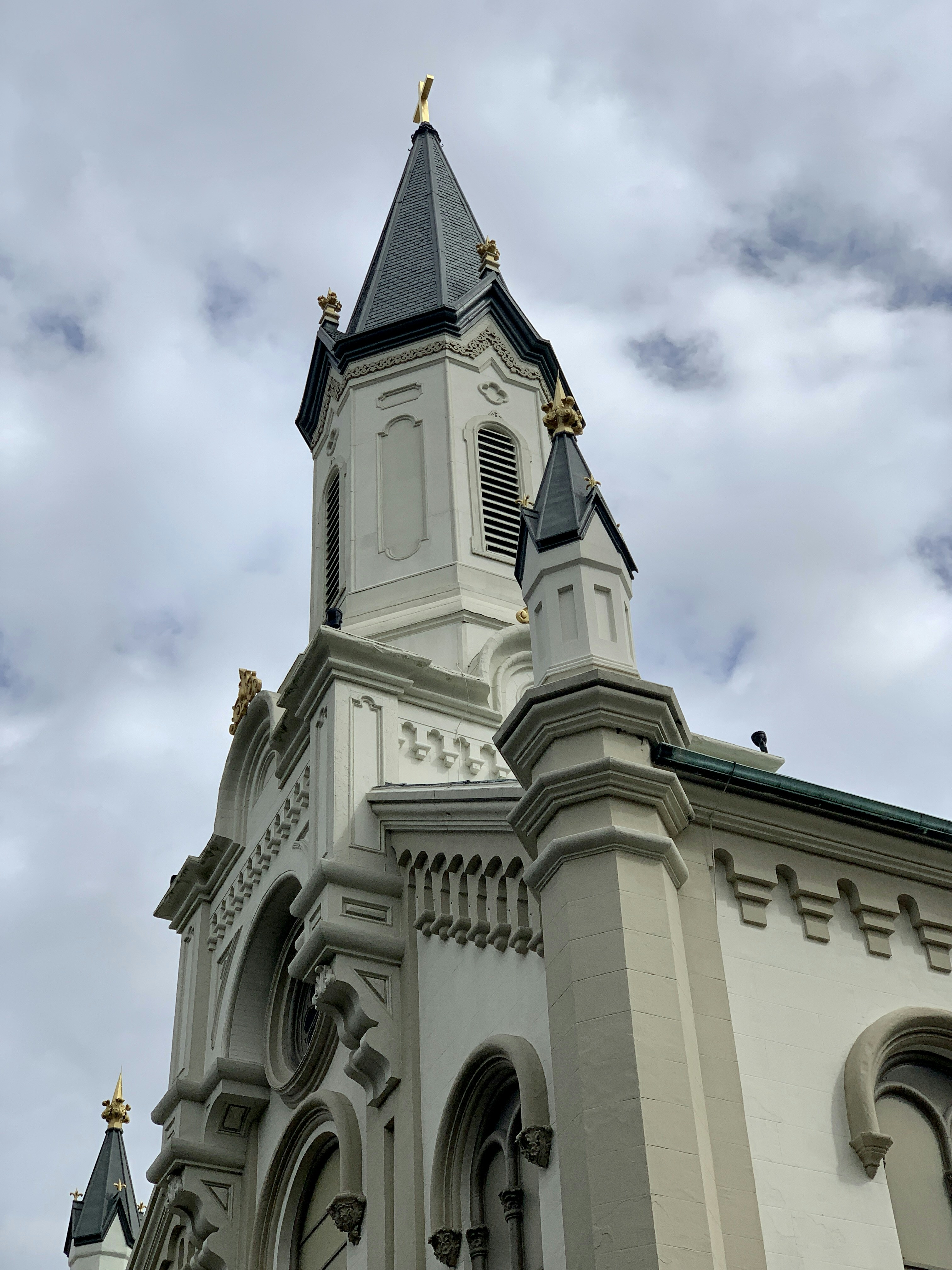 a tall white building with a clock on the top of it