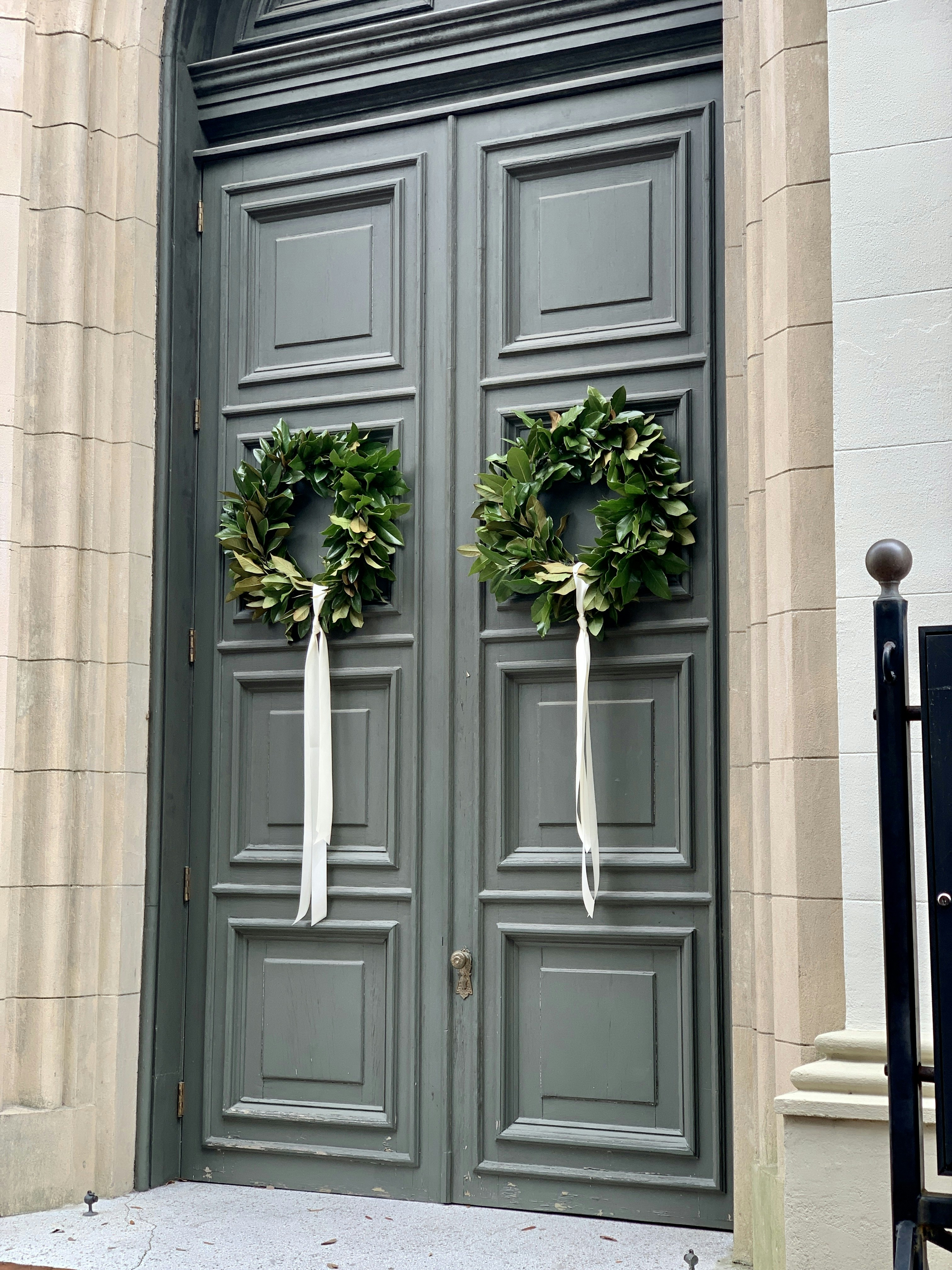 two wreaths on the front door of a building