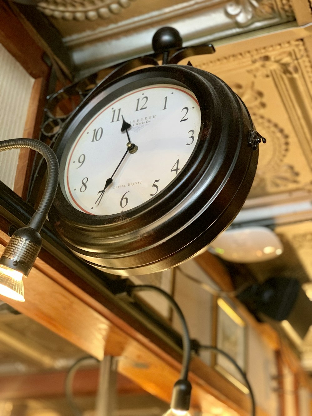 a clock hanging from the ceiling of a restaurant