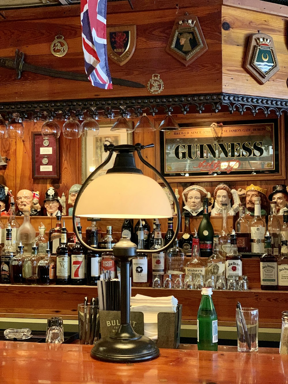 a lamp sitting on top of a wooden bar