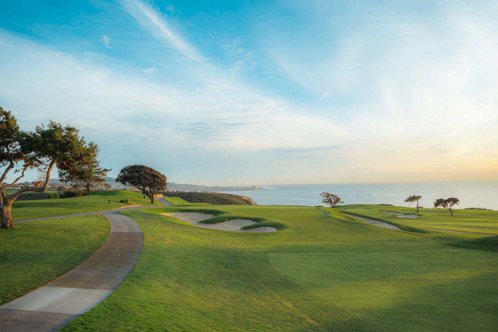 Coastal fairway with a path leading toward the sea