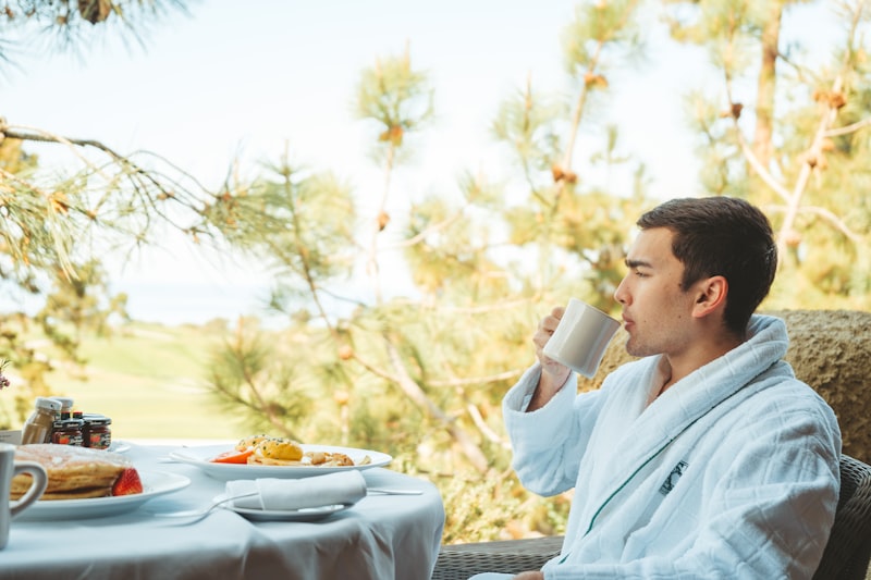 Man in bathrobe enjoying a calm morning coffee at home after retirement