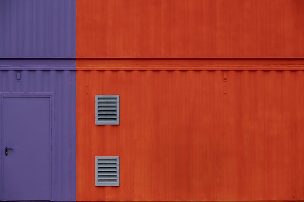 an orange and purple building with two doors