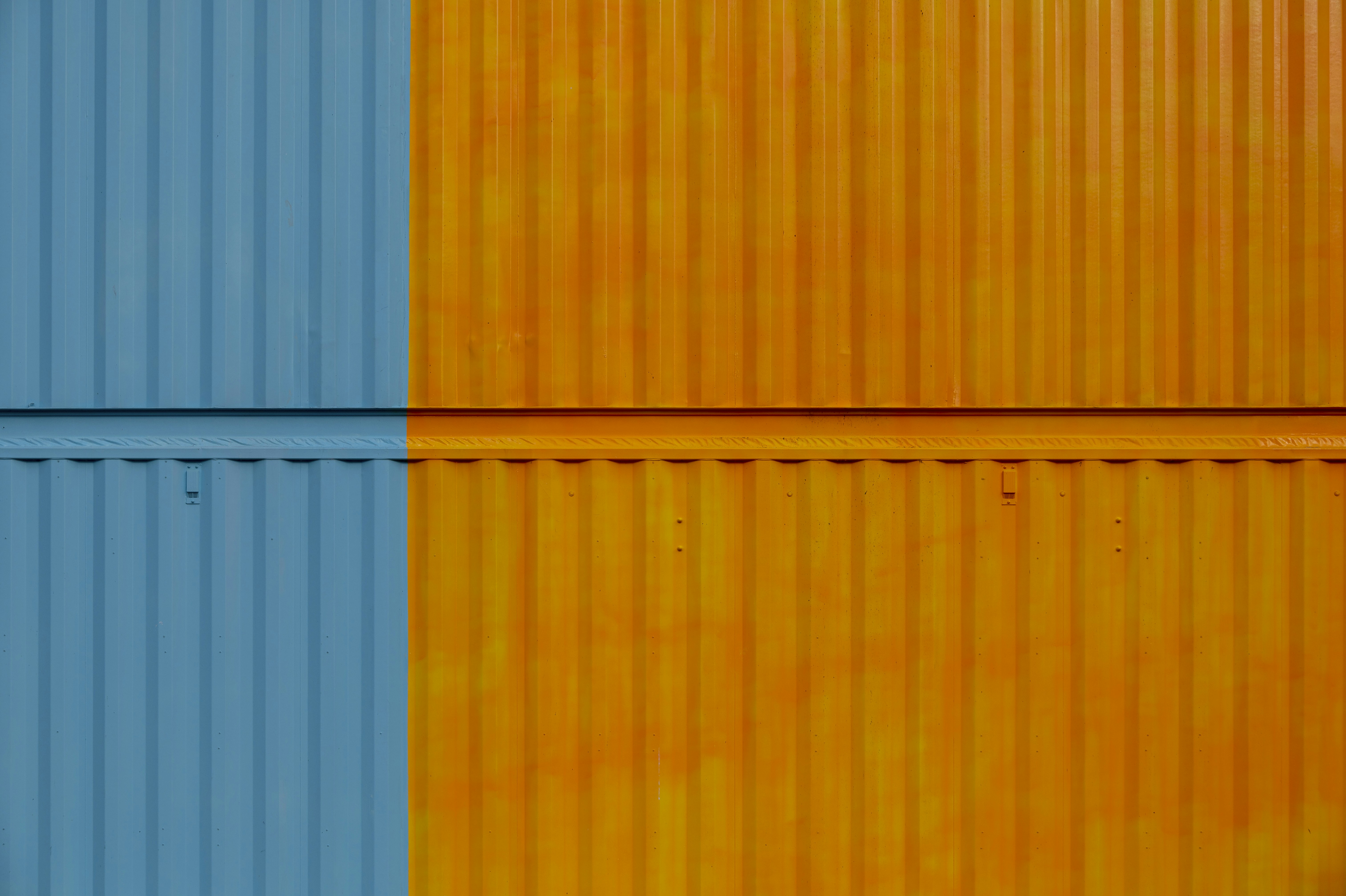 a close up of a yellow and blue wall, colored container