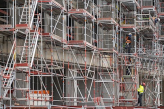 a man standing on a scaffold in front of a building