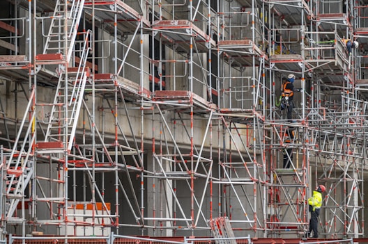a man standing on a scaffold in front of a building
