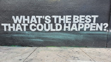 a wall with a message painted on it that says, what's the best