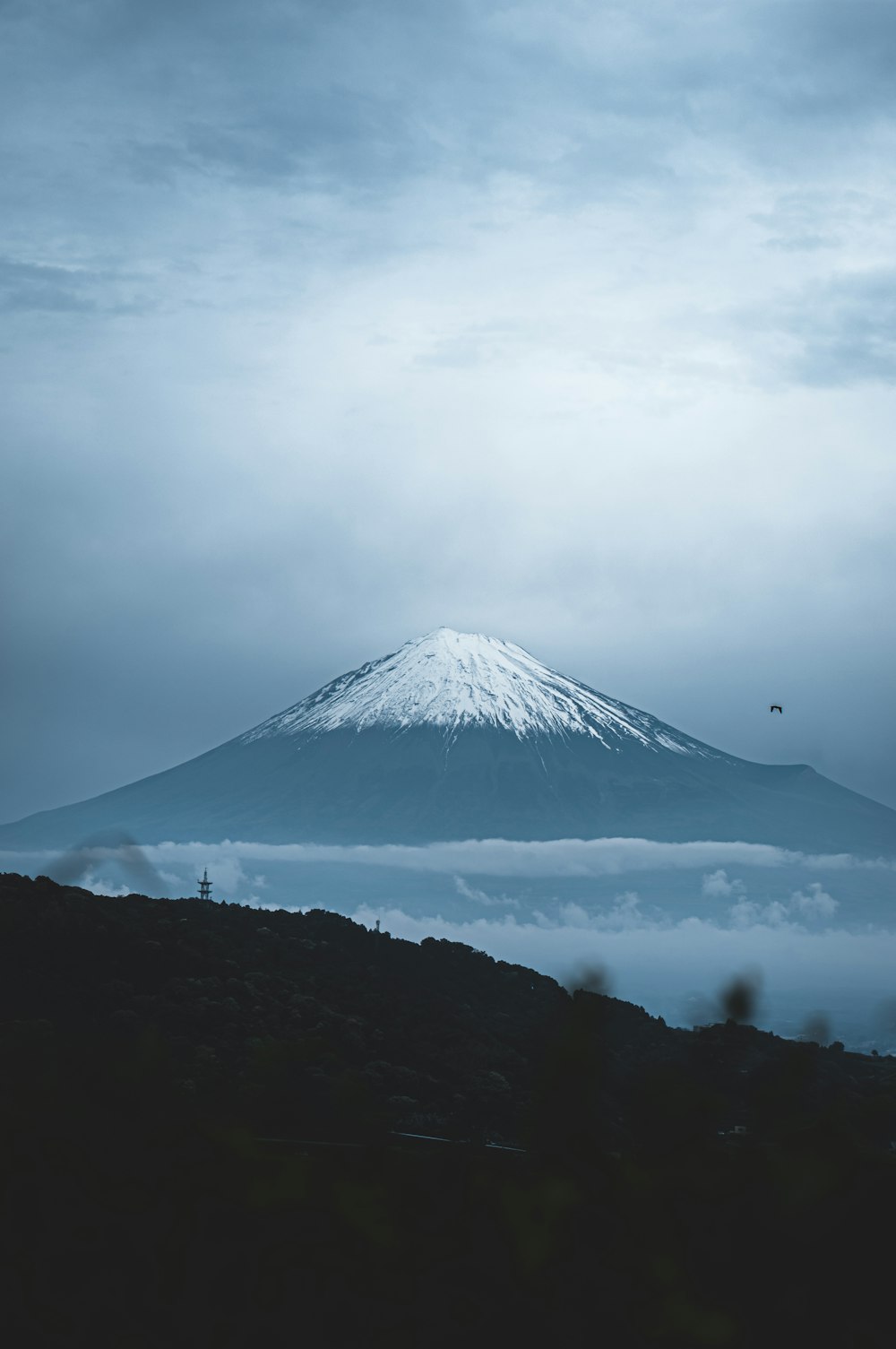 a mountain with a snow capped peak in the distance