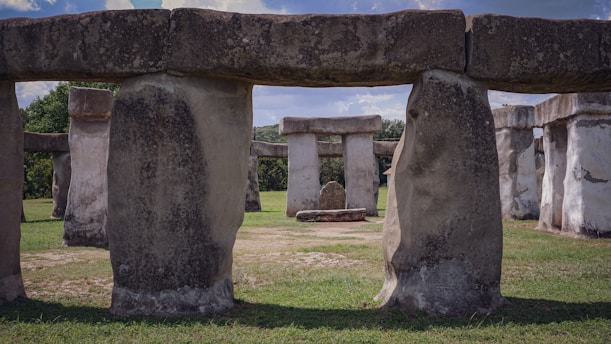 a large stone structure in a grassy area