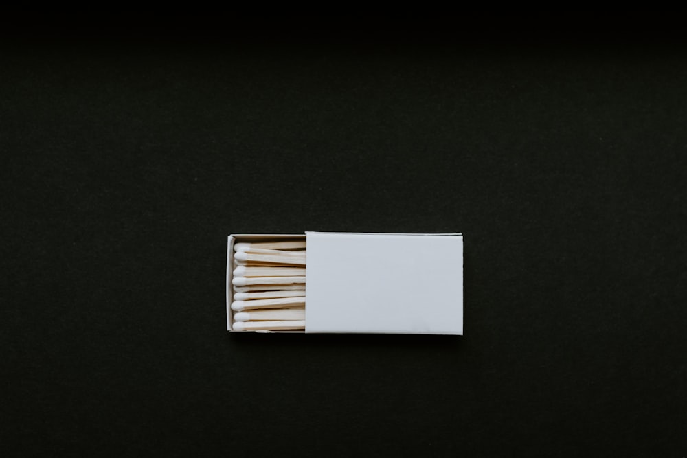 a box of matches on a black surface