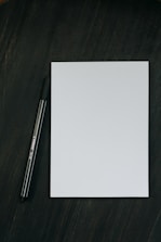 a pen sitting on top of a piece of paper
