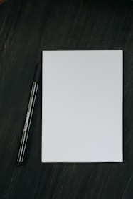 a pen sitting on top of a piece of paper