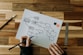 a person drawing a diagram on a piece of paper