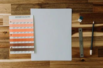 An elegant brand palette spread showing black, orange, and white color swatches alongside typography samples.