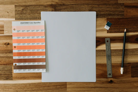 An elegant brand palette spread showing black, orange, and white color swatches alongside typography samples.