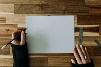 a person writing on a piece of paper
