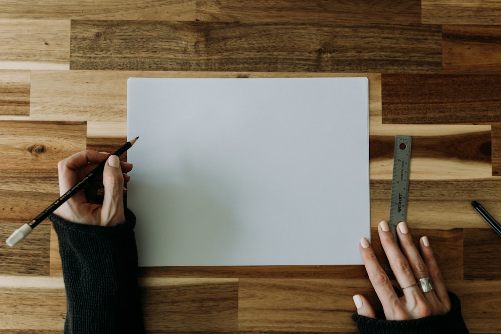 a person writing on a piece of paper