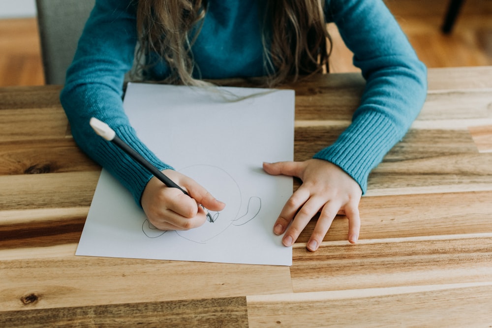 a person sitting at a table with a piece of paper