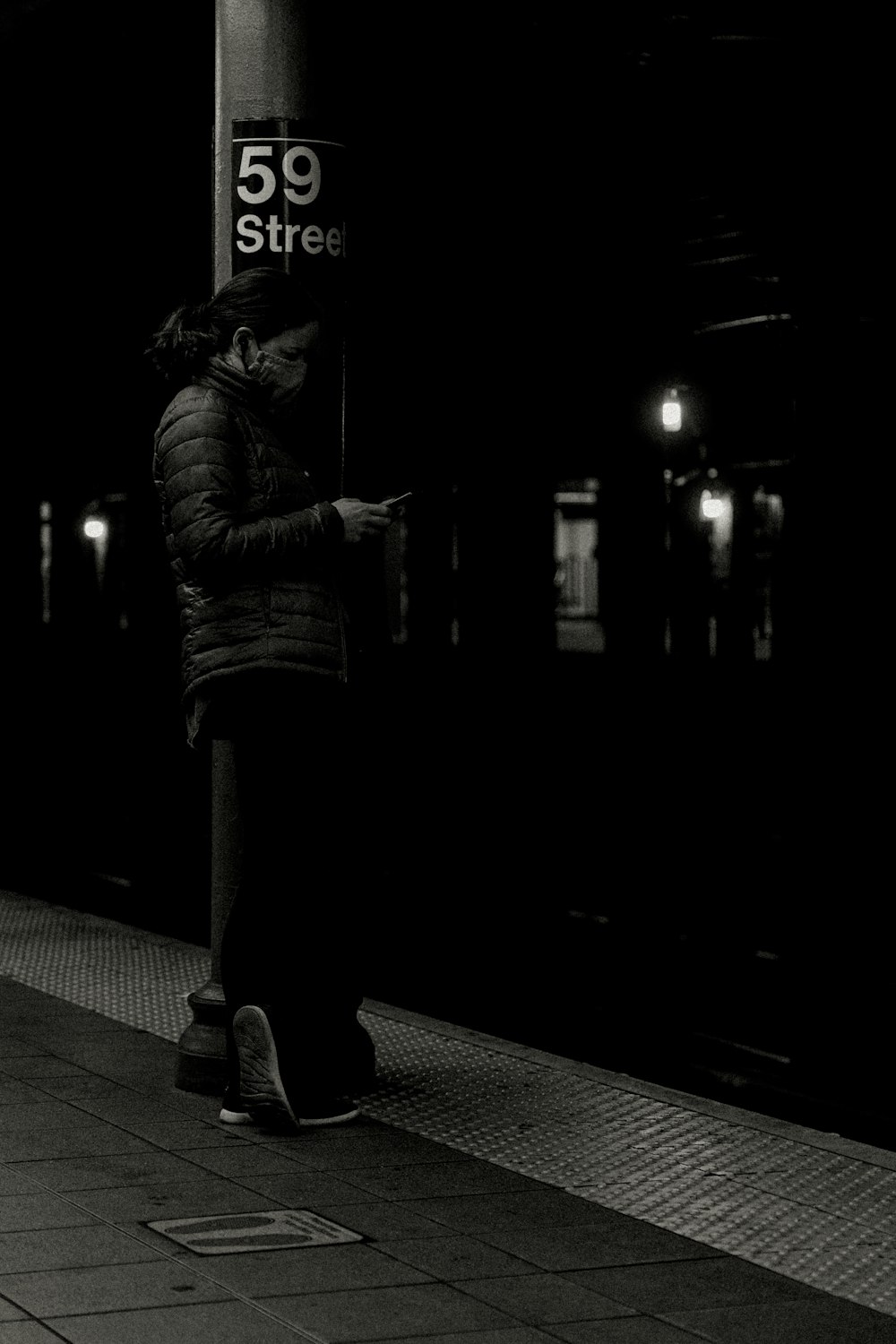 a person standing on a platform next to a train