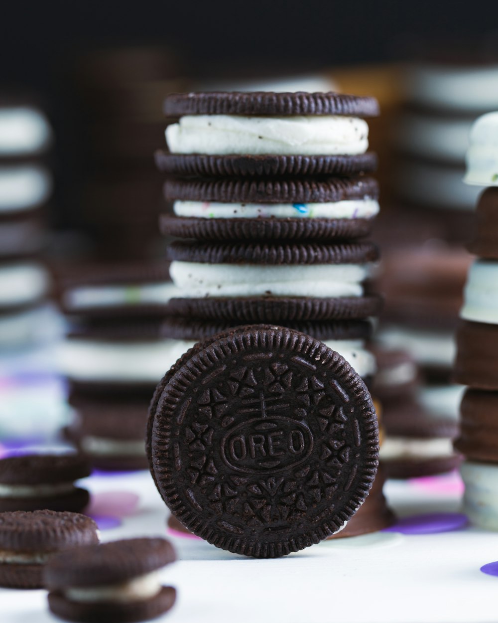 an oreo cookie sitting on top of a pile of cookies
