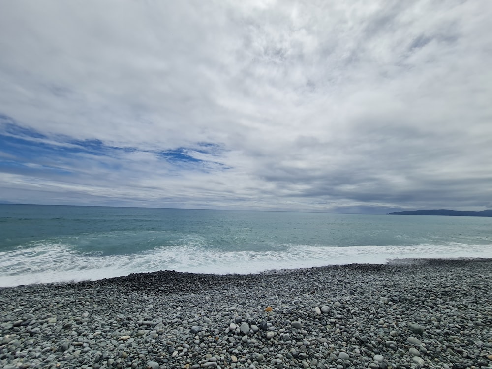 a view of the ocean from a rocky beach