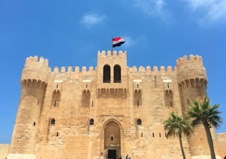 a large castle with a flag on top of it
