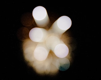 Colorful chakra symbols glowing softly in a circular pattern against a dark background