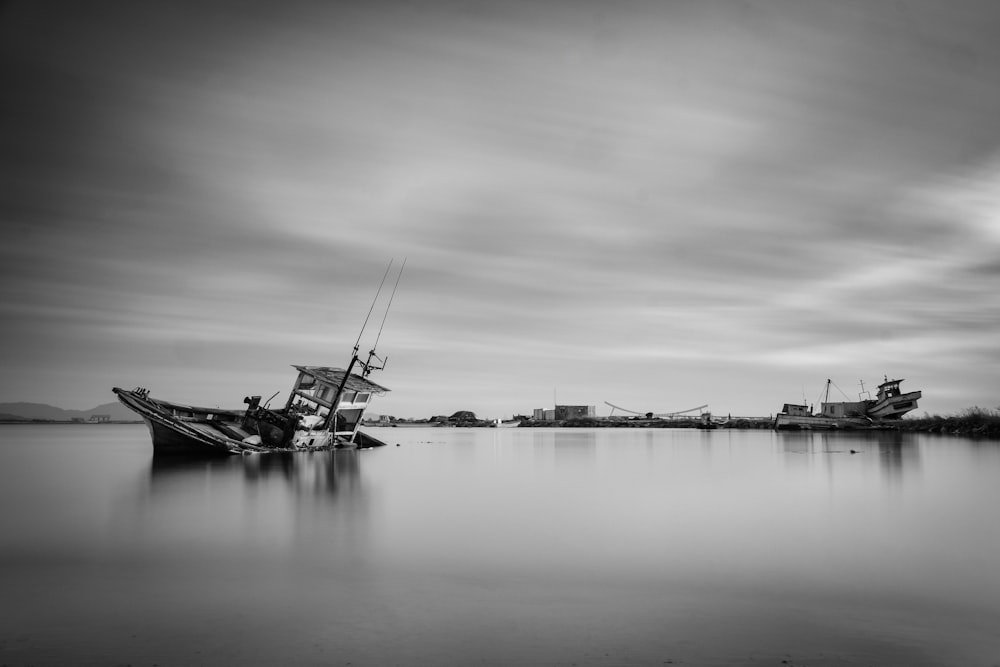 a black and white photo of a boat in the water