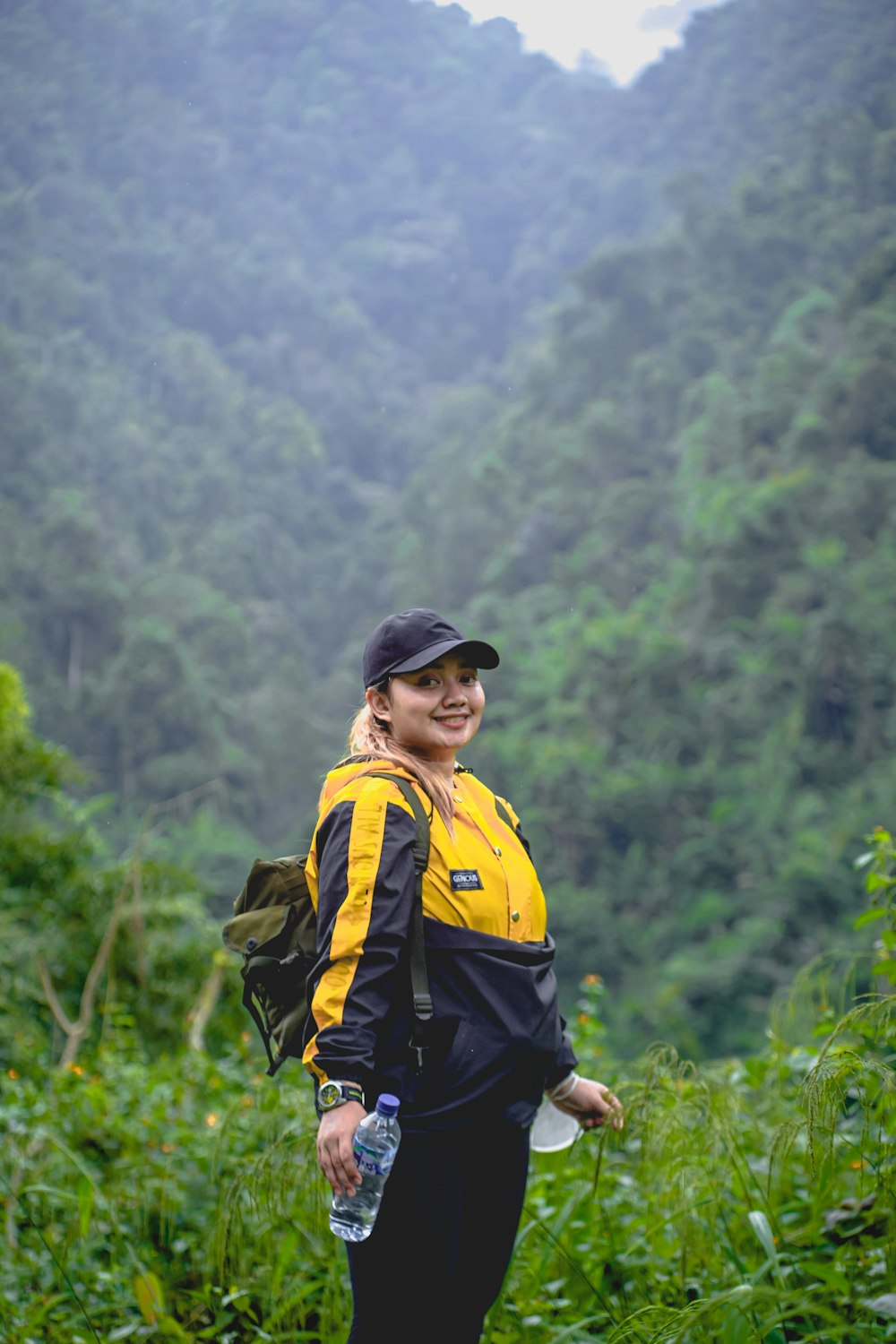 a woman with a backpack and a water bottle