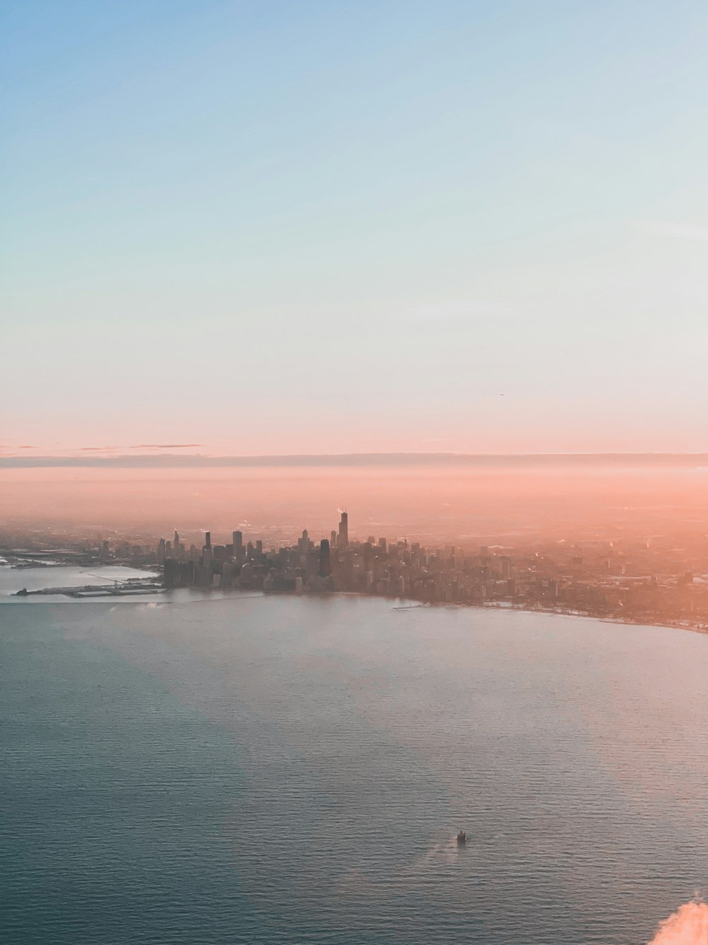 a large body of water with a city in the background