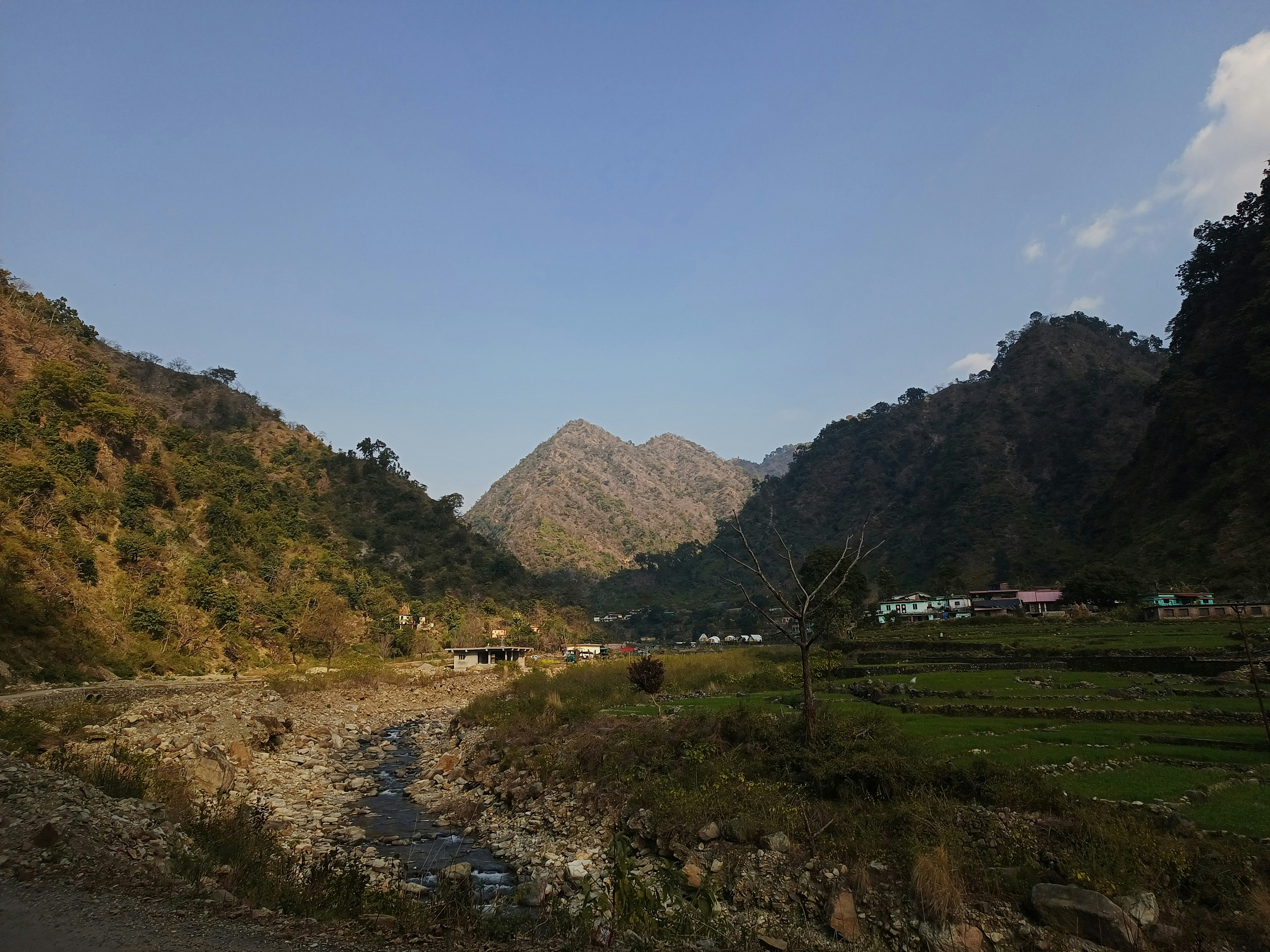 a river running through a lush green valley