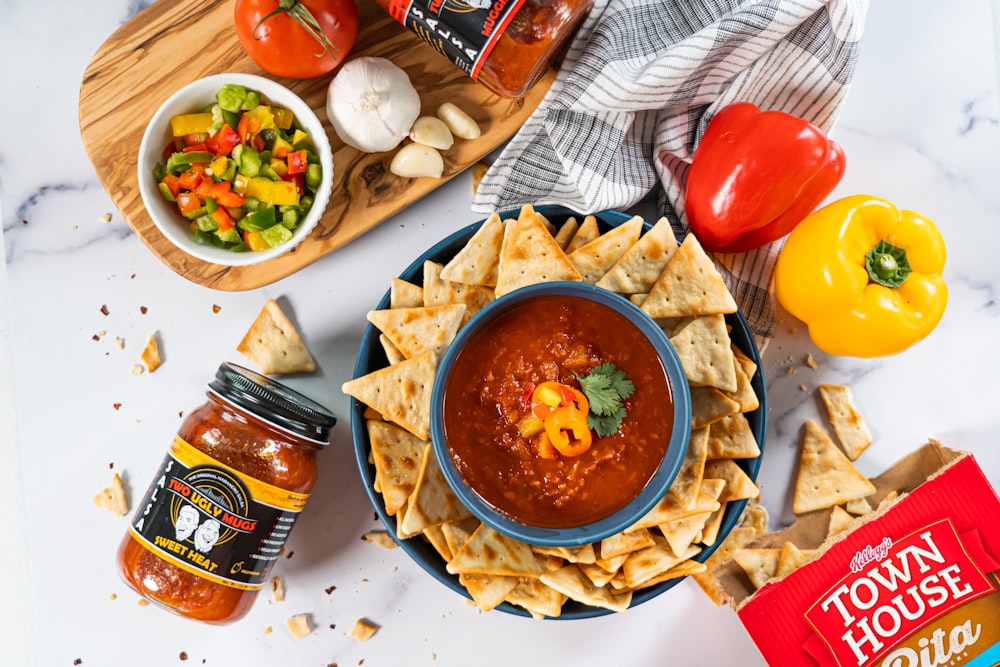 a bowl of chili and tortilla chips on a table