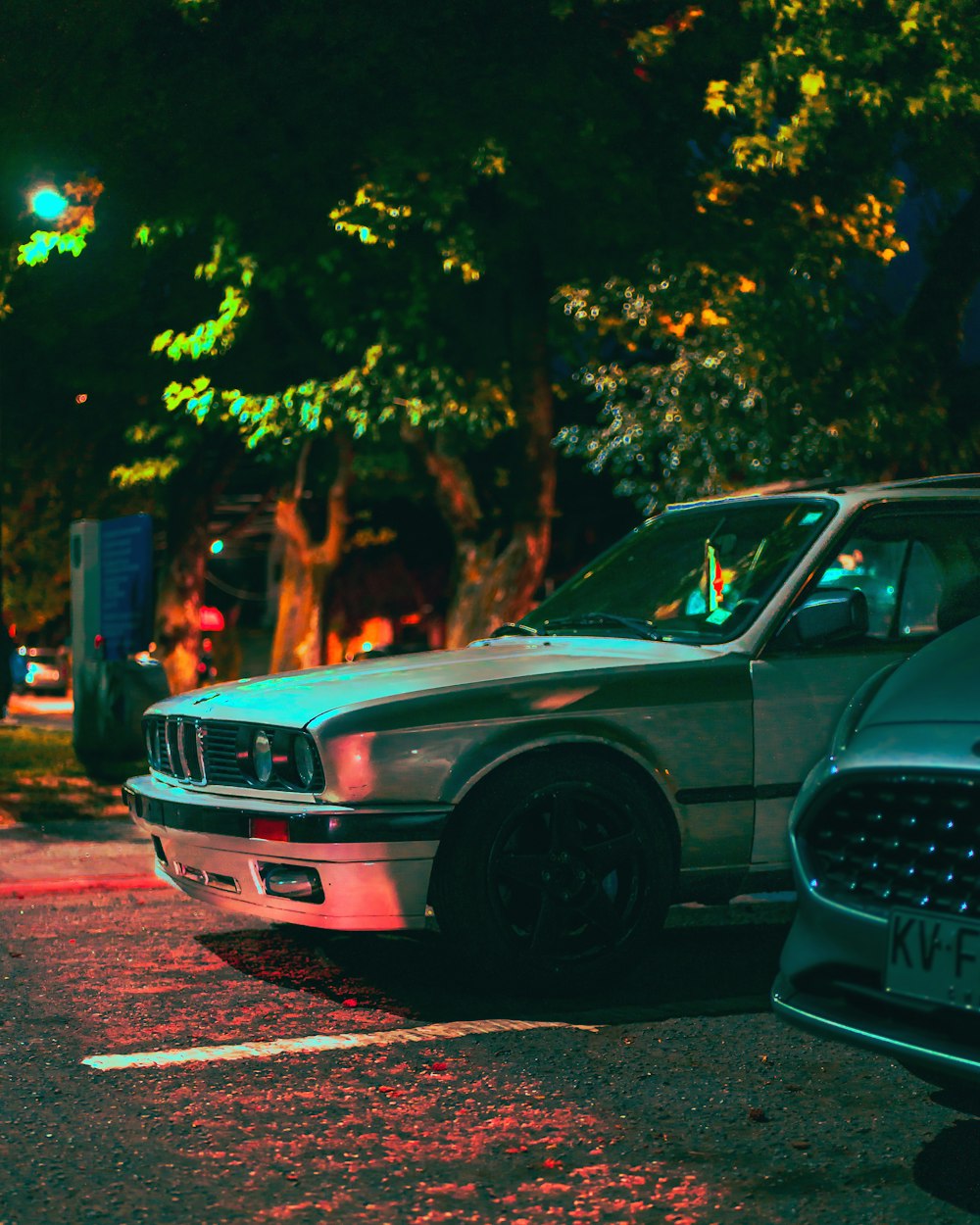 two cars parked next to each other in a parking lot