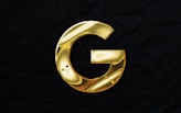 a gold letter g on a black background