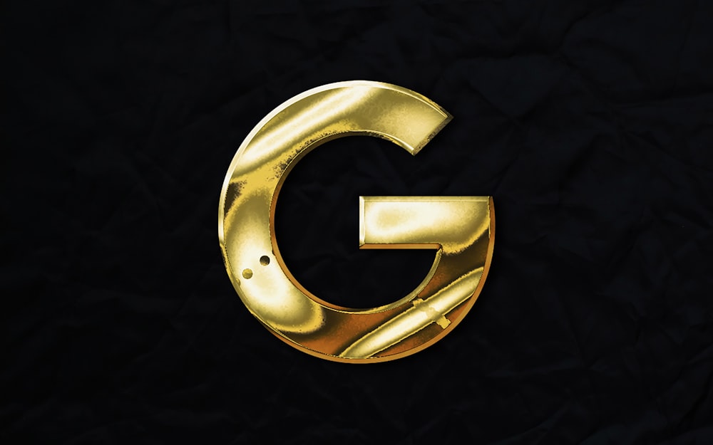 a gold letter g on a black background