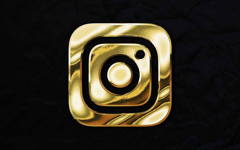 a gold instagram logo on a black background