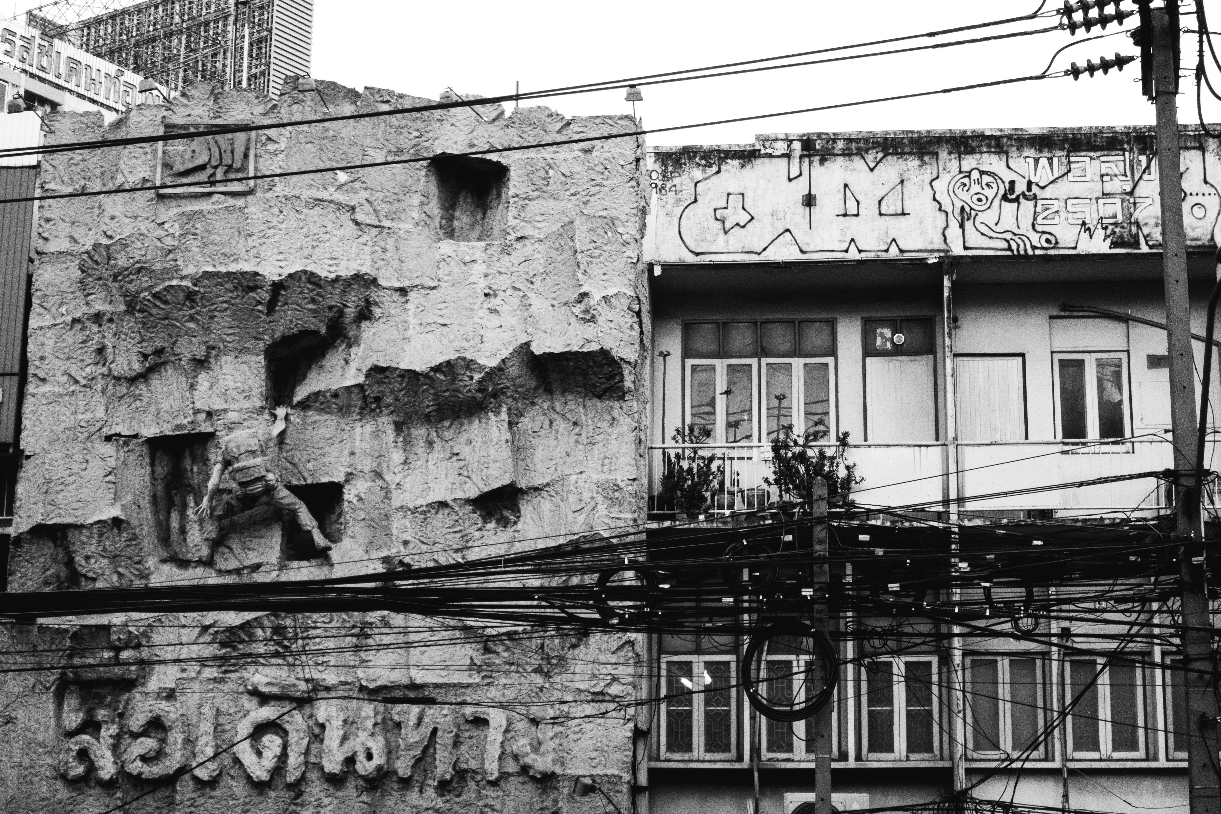 a black and white photo of a building with graffiti on it