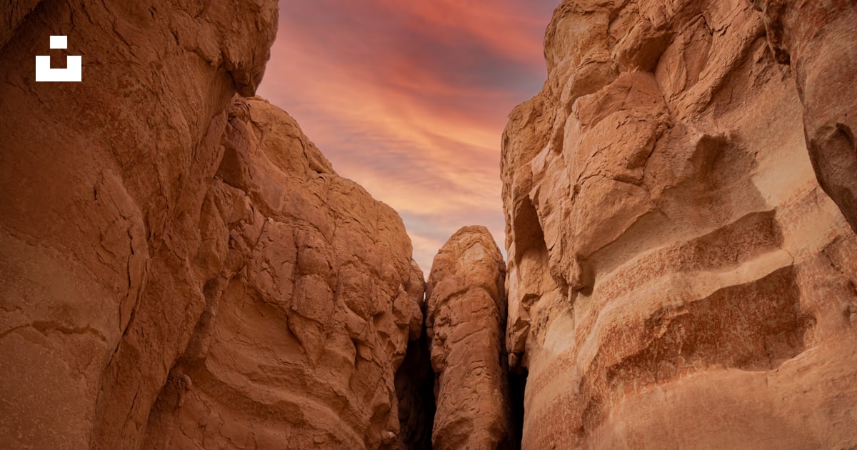 A narrow path between two large rocks in the desert photo – Free Nature ...