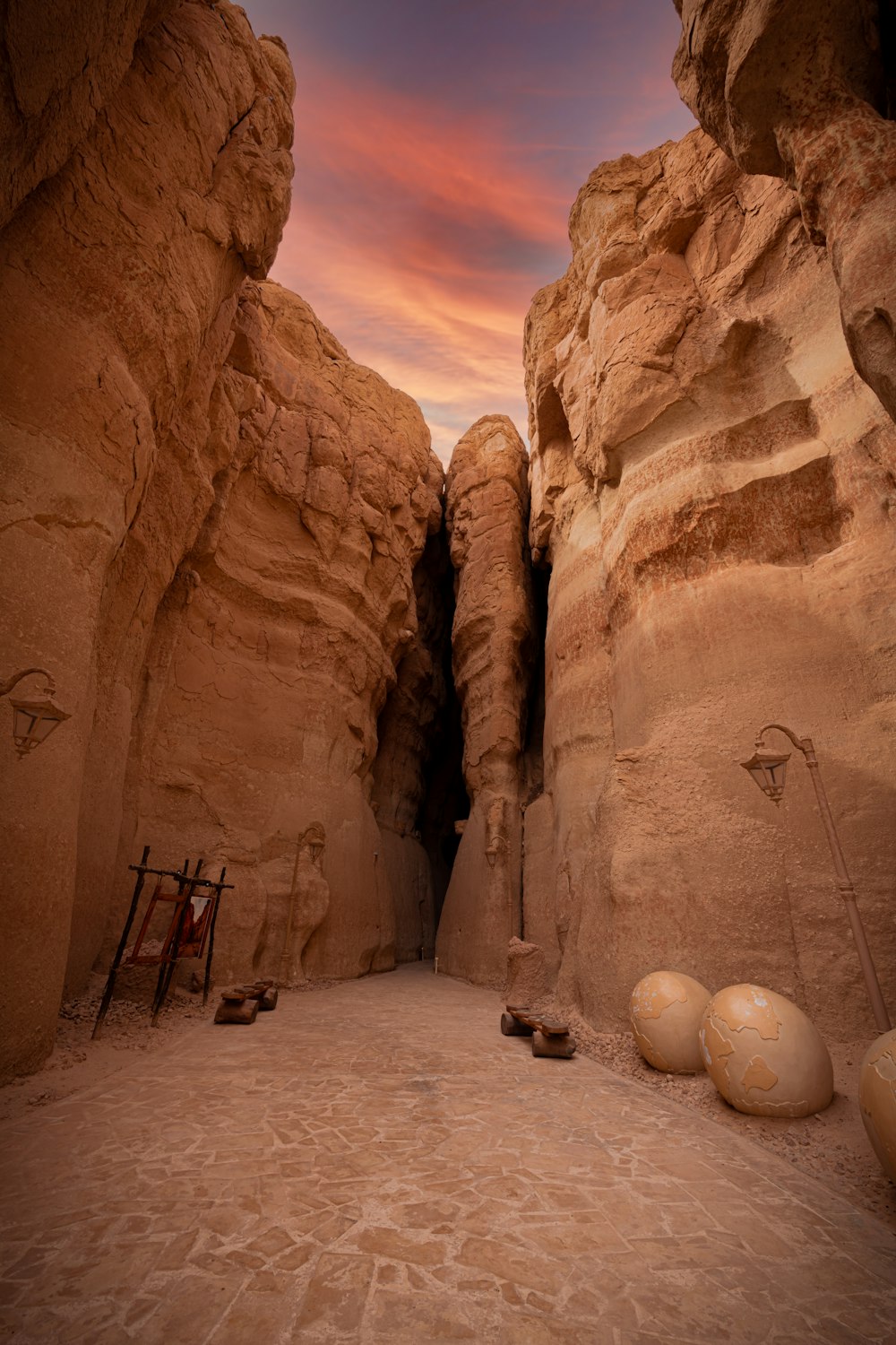 a narrow path between two large rocks in the desert