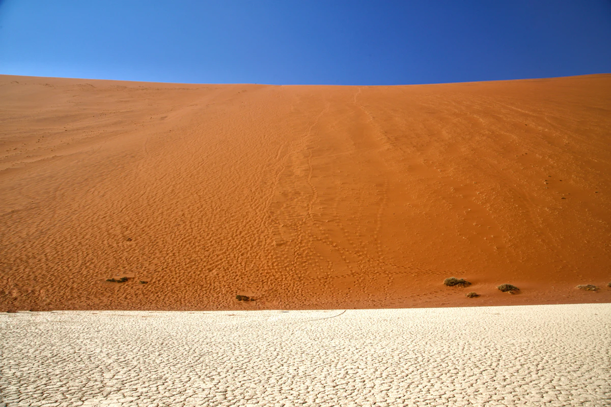Large sand dune under a blue sky