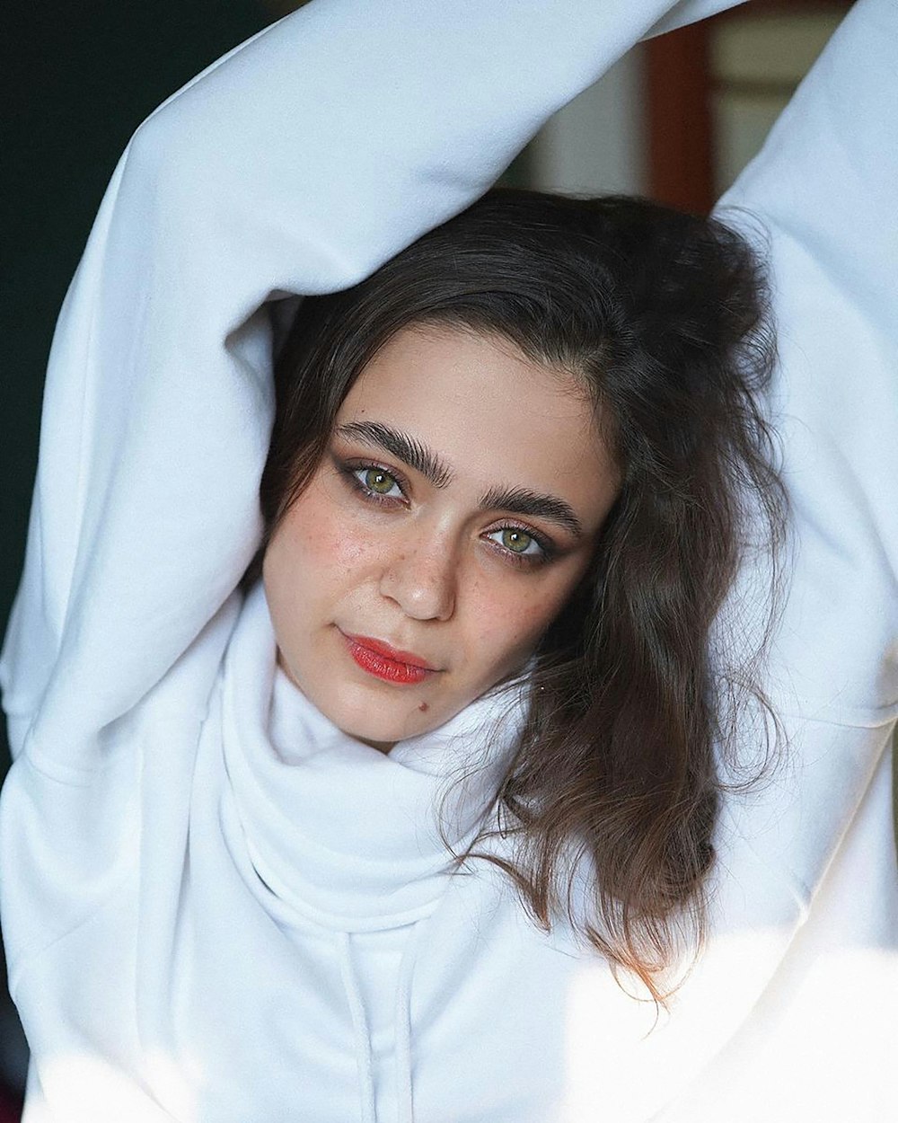 a woman with a white shirt and red lipstick