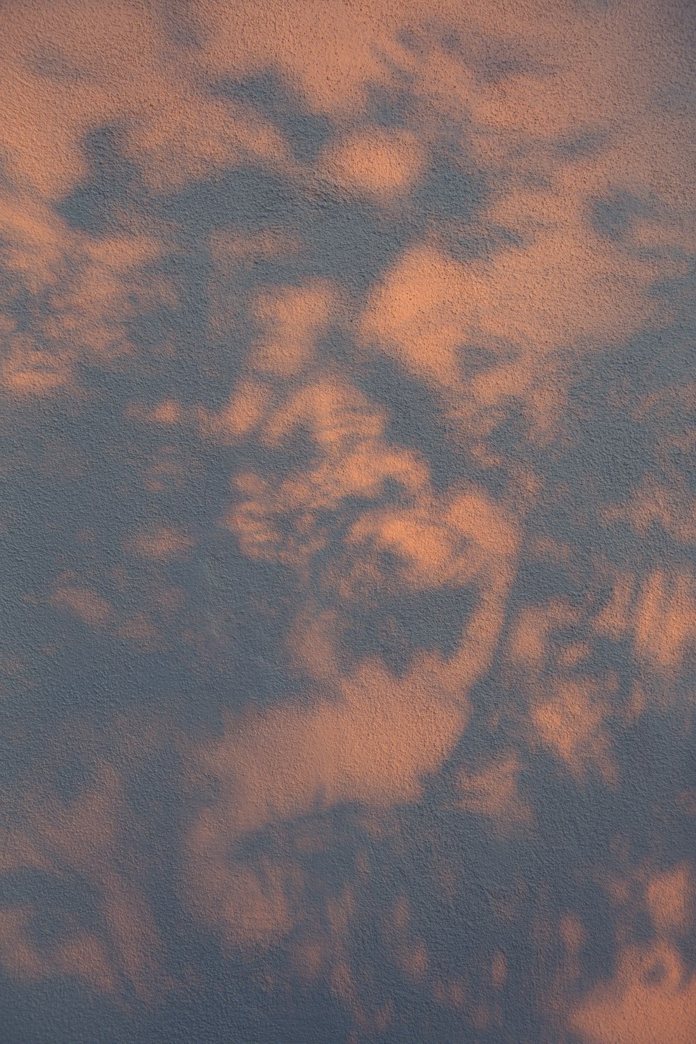 a plane flying in the sky at sunset