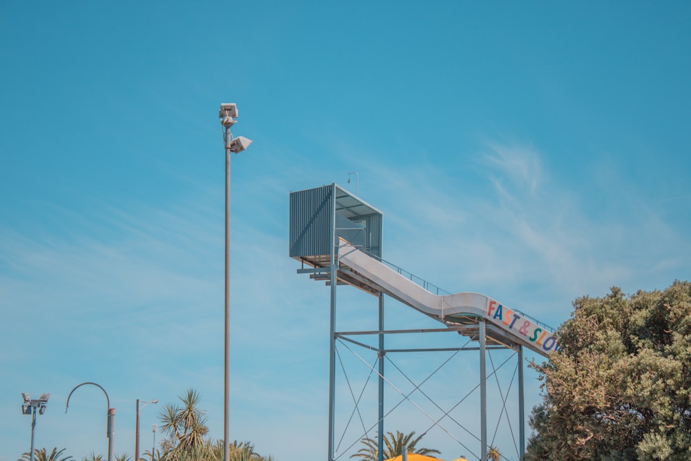 a tall metal structure with a sign on top of it