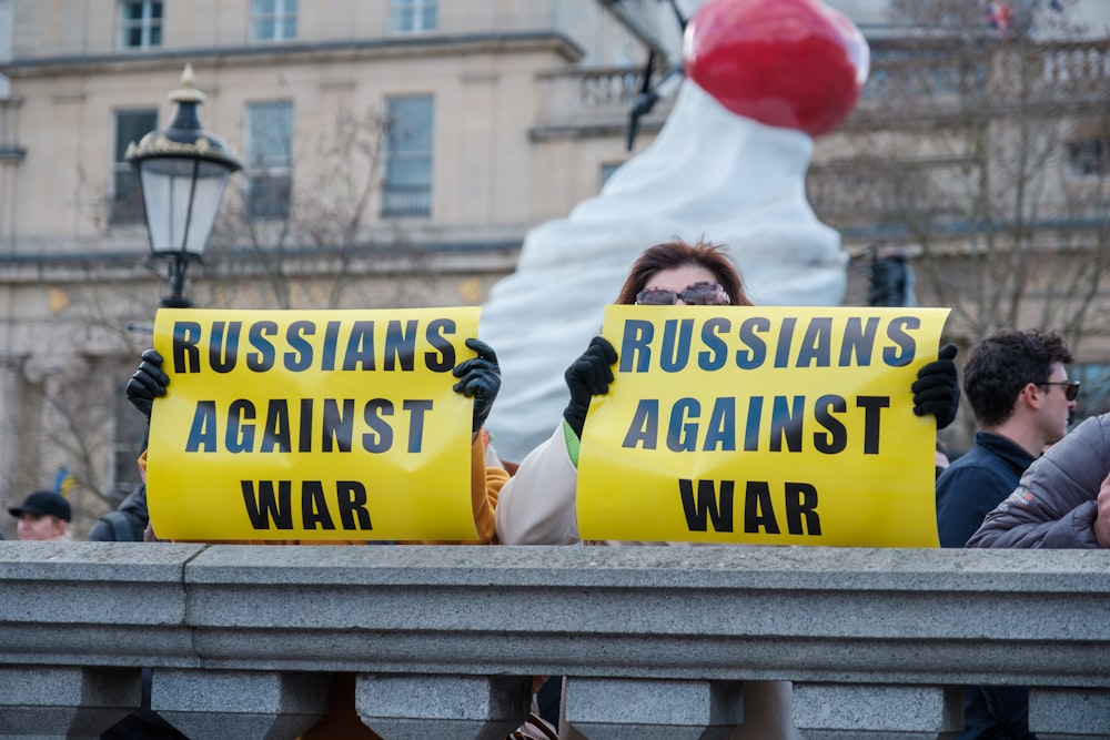 a group of people holding up yellow signs