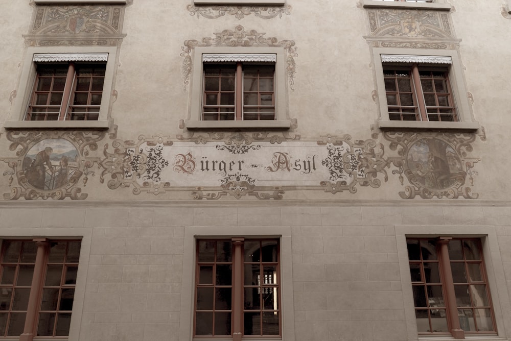 a building with windows and a sign on the side of it